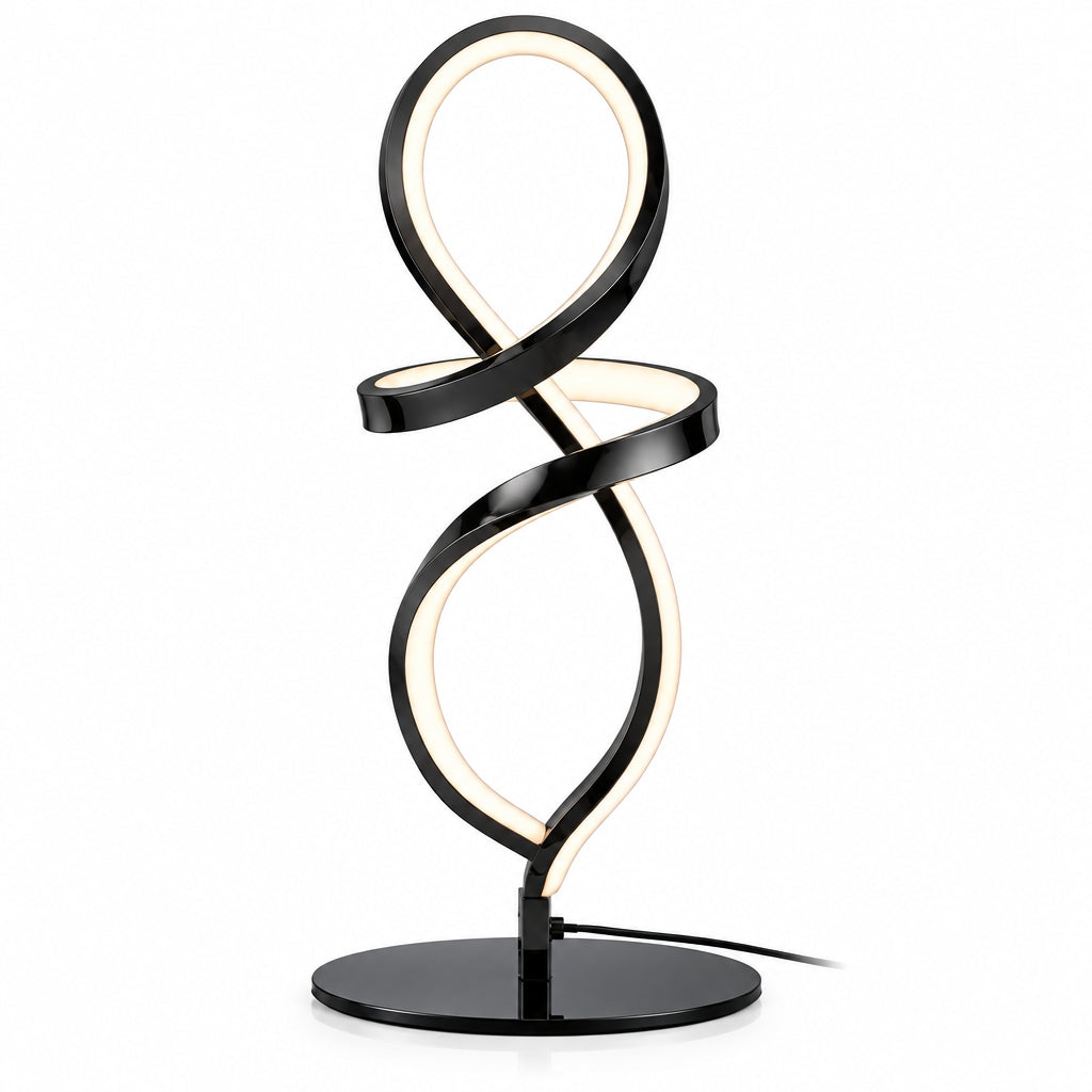 Modern black spiral table lamp on a desk with a plant and books in the background