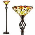 A traditional floor lamp with a black metal frame and a multi-colored stained glass shade featuring yellow, orange, and blue tones.